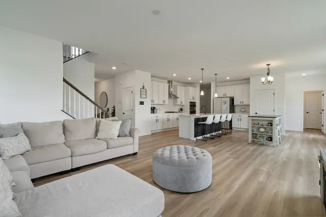 a living room with furniture and kitchen view