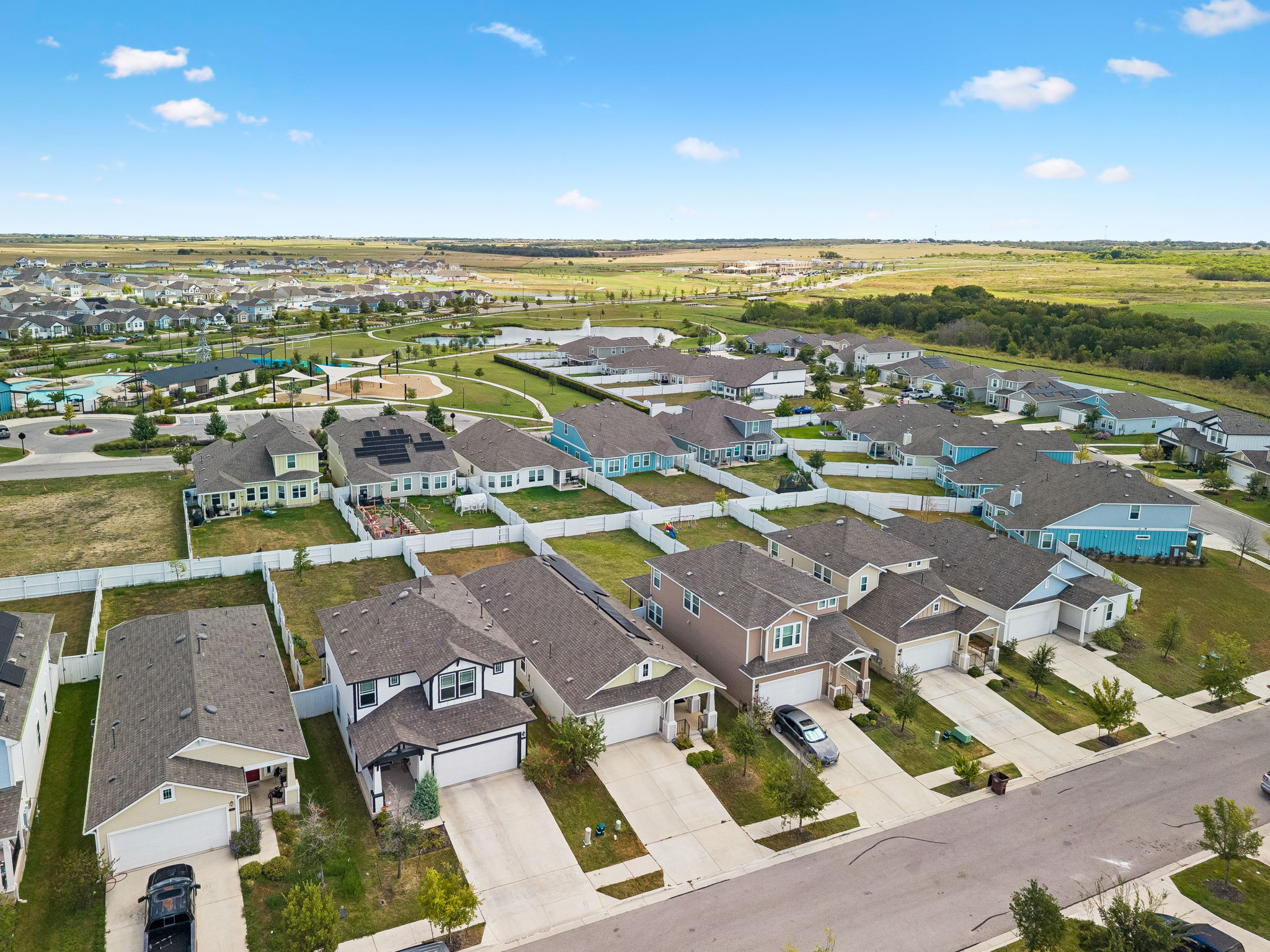 164 Appleberry Lane Elgin, TX 78621 - Photo 29 of 40 An aerial perspective showcases modern suburban homes surrounded by green spaces and community sidewalks.