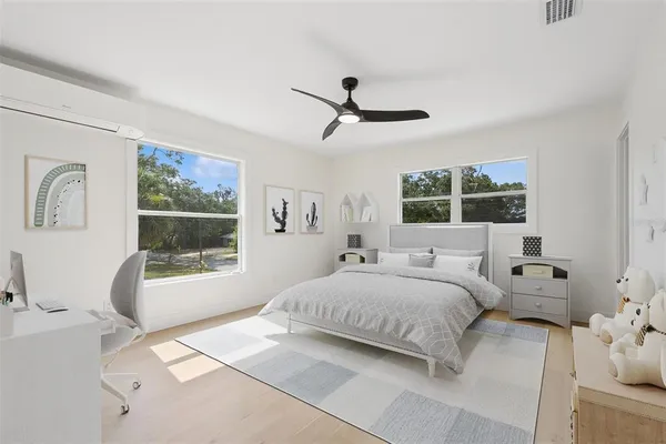 a bedroom with a bed and a window