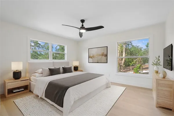 a bedroom with a large bed and a flat screen tv