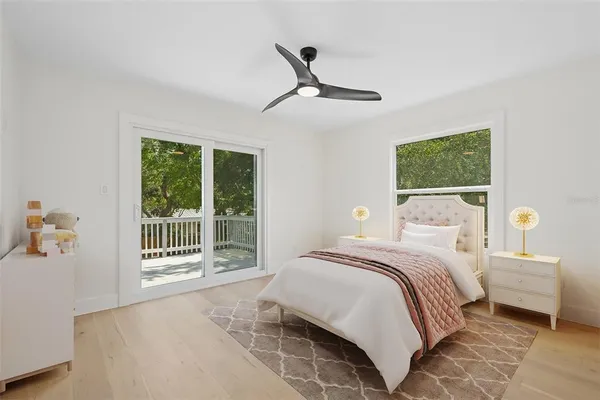 a bedroom with a bed and a large window