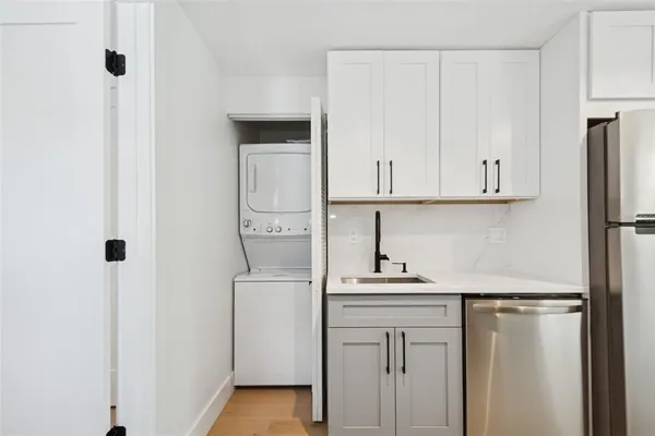 a kitchen with stainless steel appliances white cabinets and a refrigerator