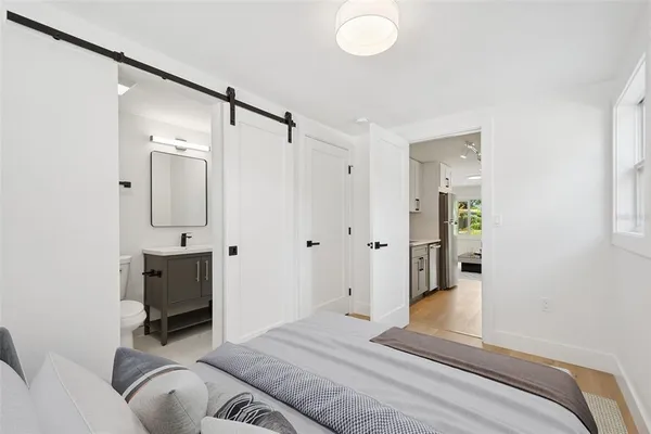 a bedroom with a bed and a chandelier