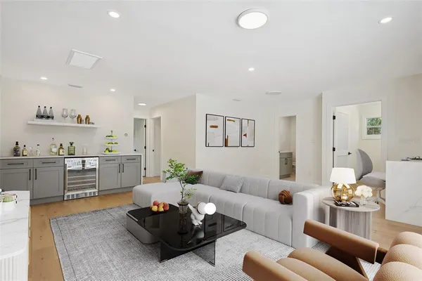 a living room with furniture and kitchen view