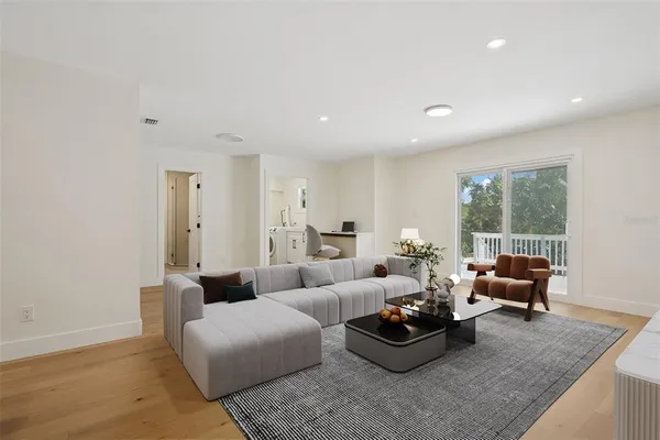 a living room with furniture potted plant and a window