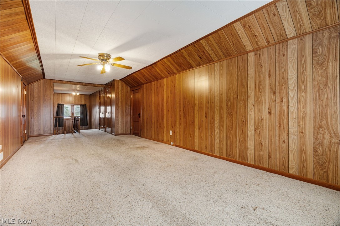 1640 Old Delaware Road Mount Vernon, OH 43050 - Photo 32 of 49 Unfurnished living room with wooden walls, carpet flooring, and ceiling fan