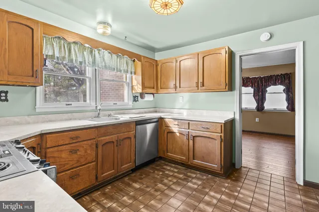a view of a kitchen with refrigerator and cabinet