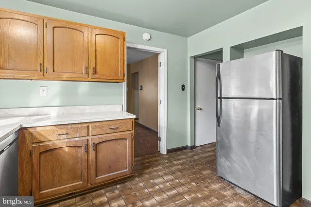 a view of a dining room with furniture a chandelier and wooden floor