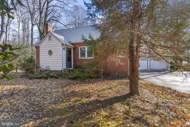 a view of a house with a yard covered in snow
