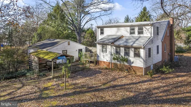 a view of a house with a yard and sitting area