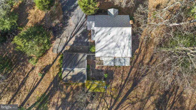 a view of a dry yard with wooden fence