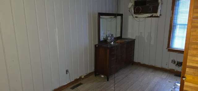 a room that has a dresser in it