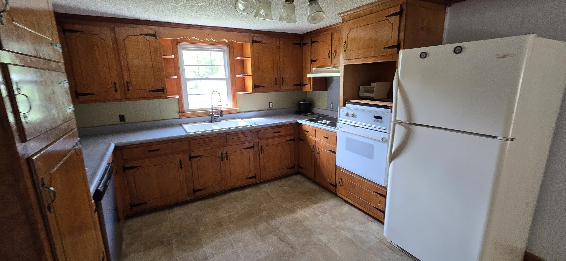 117 Pleasant View Road White Bluff, TN 37187 - Photo 6 of 21 a kitchen with stainless steel appliances a refrigerator sink and wooden cabinets