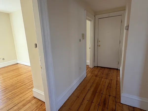 a view of a room with wooden floor