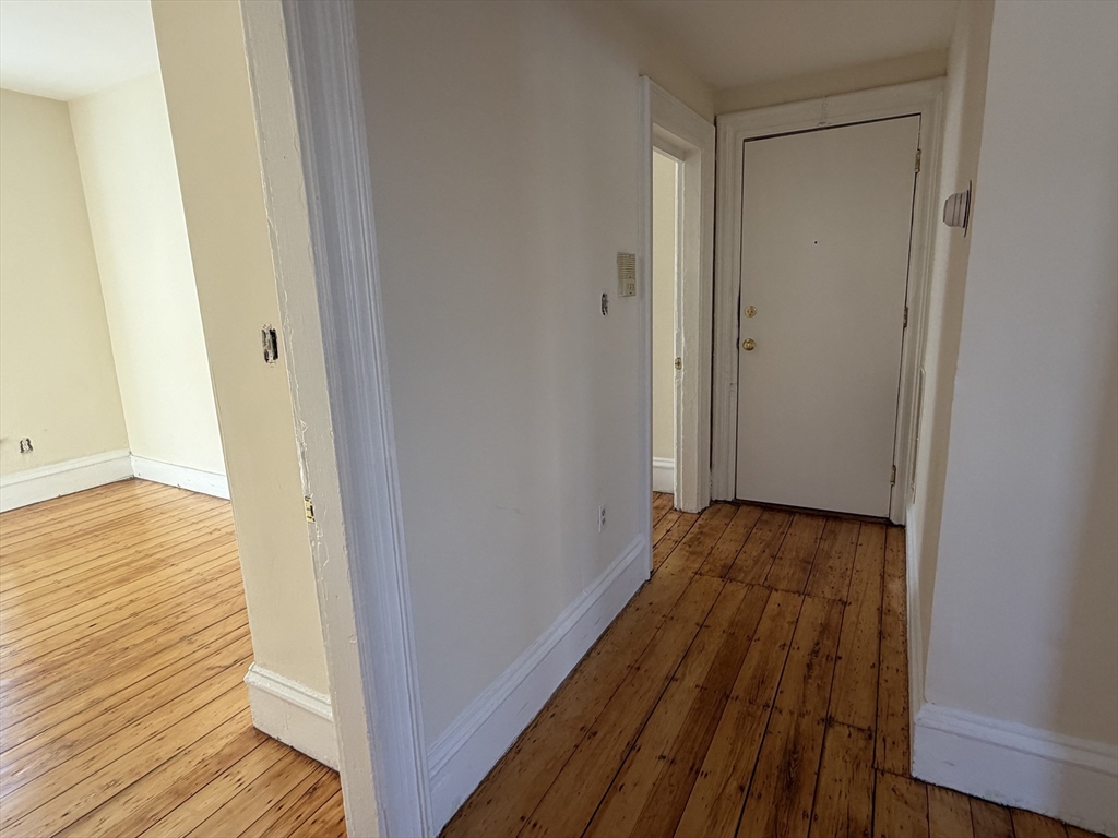 227 Roxbury Street, Unit 4 Boston, MA 02119 - Photo 3 of 7 a view of a room with wooden floor
