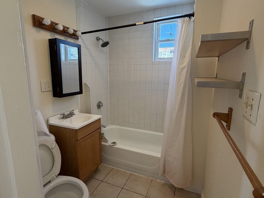 227 Roxbury Street, Unit 4 Boston, MA 02119 - Photo 7 of 7 a bathroom with a sink toilet and shower