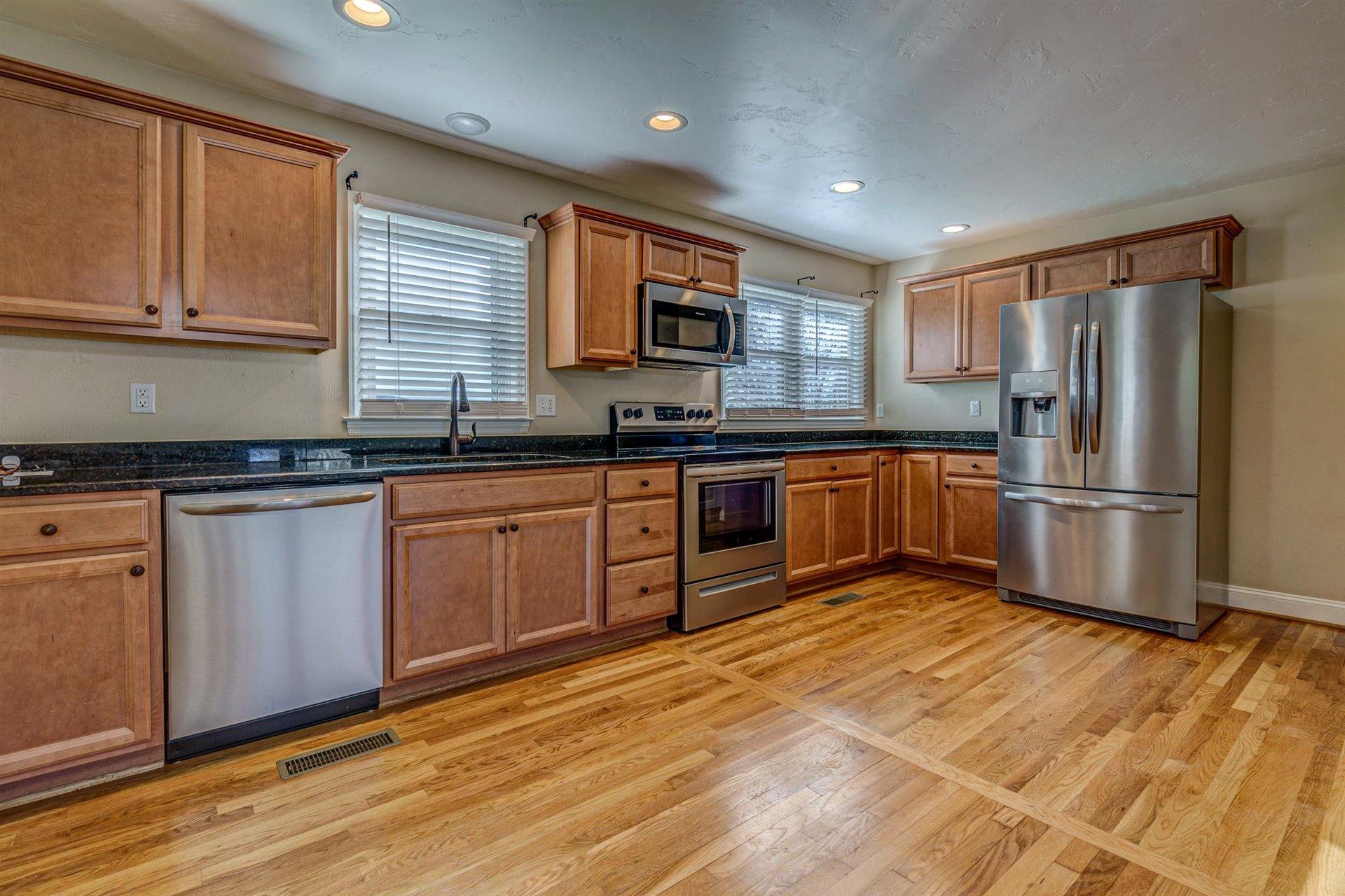 398 Jamestown Road Rocky Mount, VA 24151 - Photo 13 of 42 a kitchen with stainless steel appliances granite countertop a sink stove and refrigerator