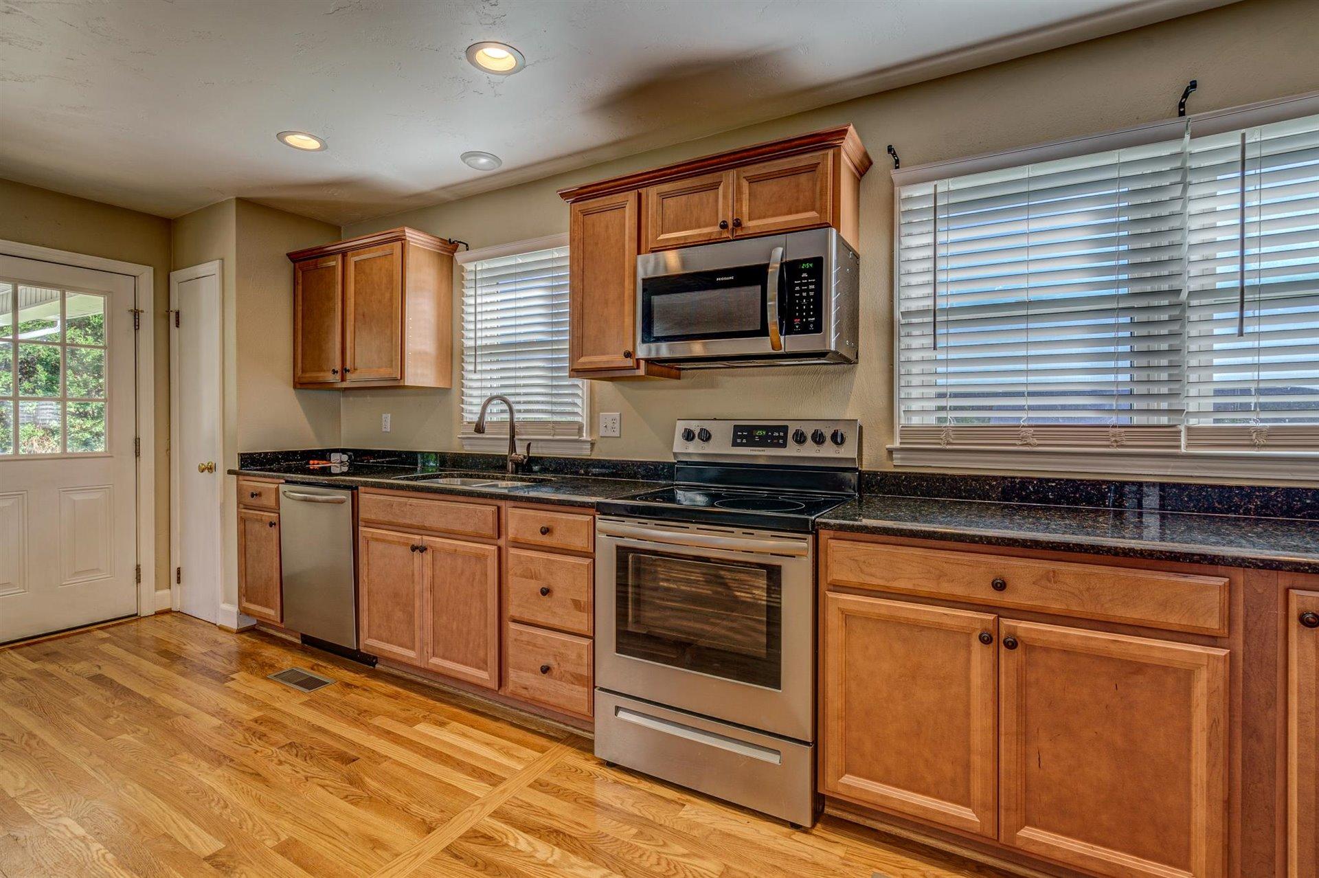 398 Jamestown Road Rocky Mount, VA 24151 - Photo 14 of 42 a kitchen with stainless steel appliances granite countertop a sink a stove and microwave