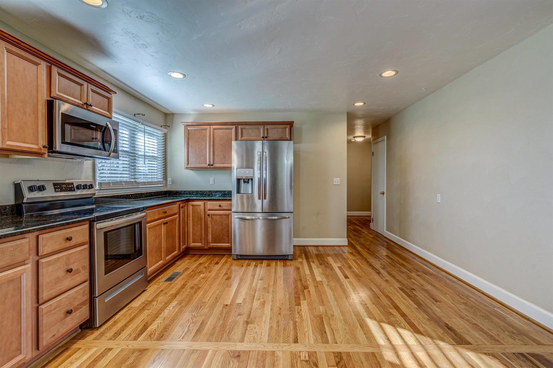 398 Jamestown Road Rocky Mount, VA 24151 - Photo 15 of 42 a large kitchen with stainless steel appliances granite countertop a stove and a sink