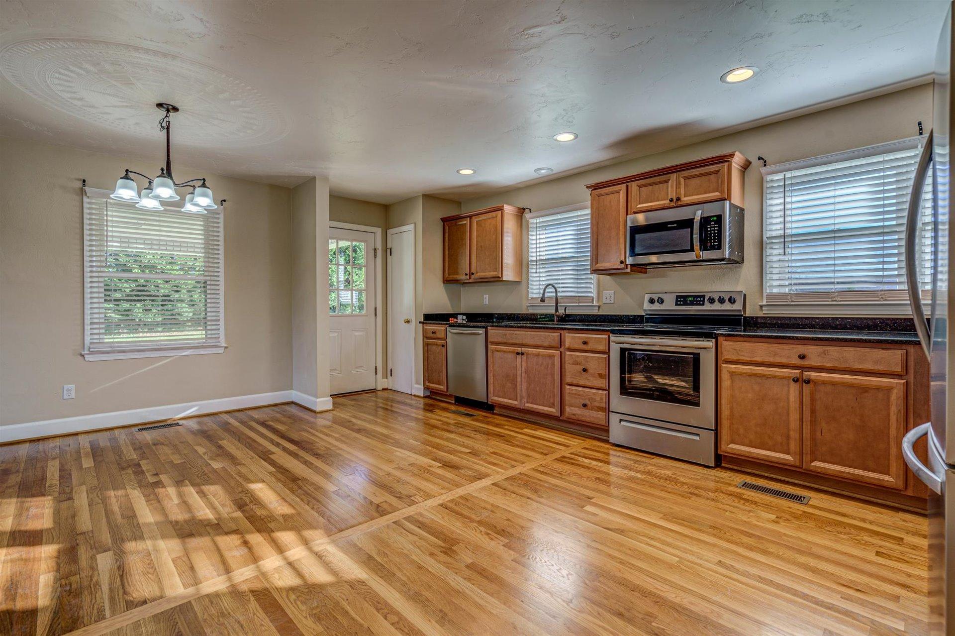 398 Jamestown Road Rocky Mount, VA 24151 - Photo 16 of 42 a kitchen with stainless steel appliances granite countertop a stove a sink and a microwave