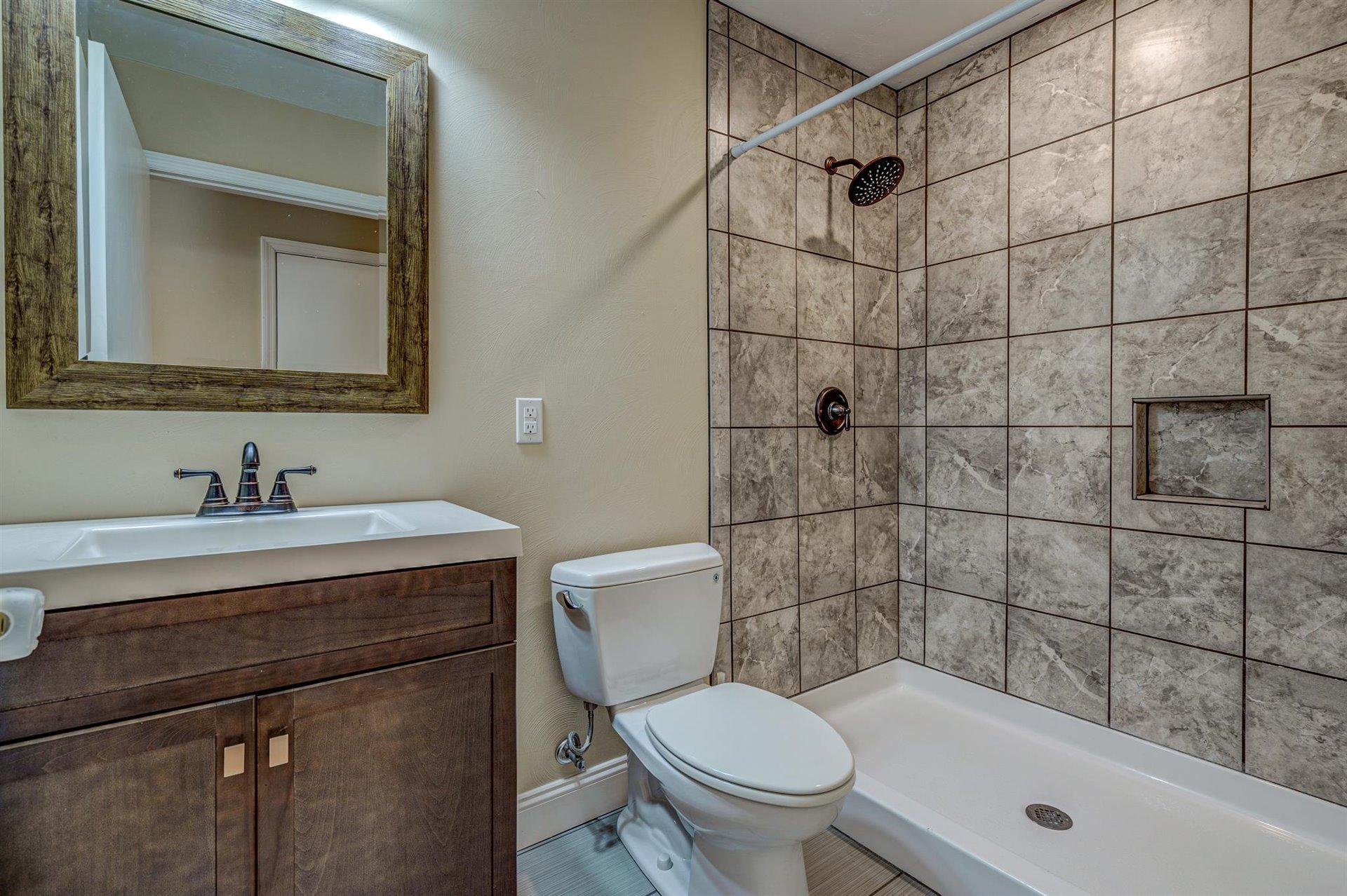 398 Jamestown Road Rocky Mount, VA 24151 - Photo 17 of 42 a bathroom with a sink a toilet and shower