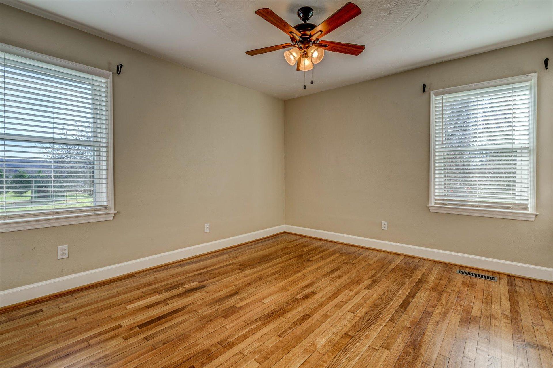 398 Jamestown Road Rocky Mount, VA 24151 - Photo 19 of 42 a view of an empty room with wooden floor and a window