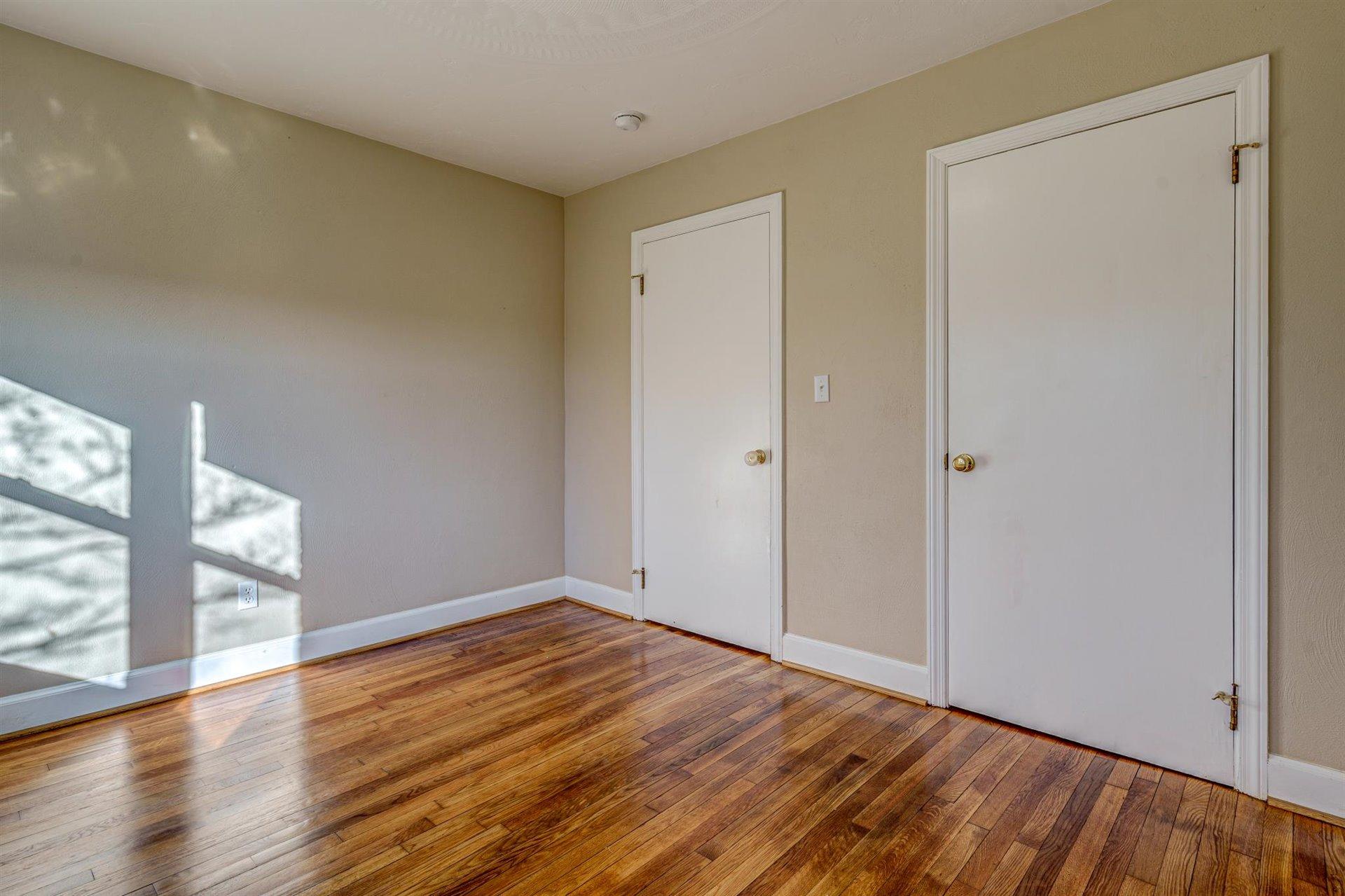 398 Jamestown Road Rocky Mount, VA 24151 - Photo 23 of 42 a view of an empty room with wooden floor and a window