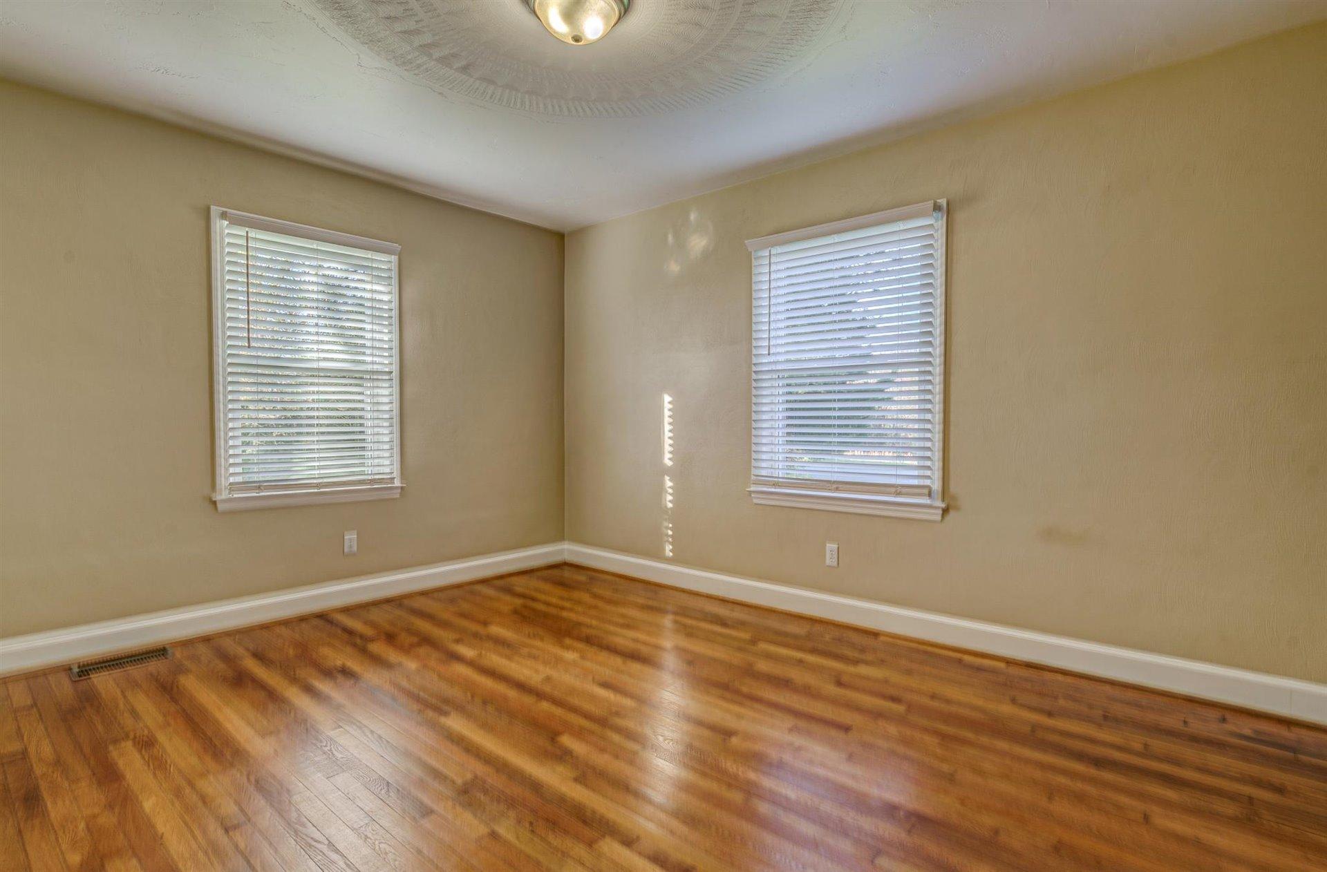 398 Jamestown Road Rocky Mount, VA 24151 - Photo 25 of 42 a view of an empty room with wooden floor and a window