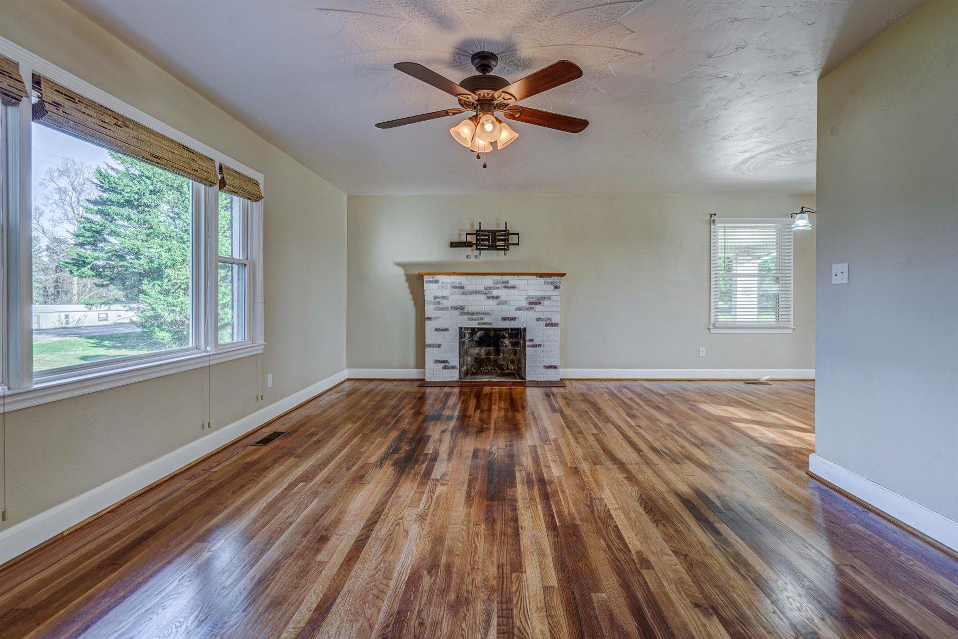 398 Jamestown Road Rocky Mount, VA 24151 - Photo 10 of 42 a view of an empty room with wooden floor and a window
