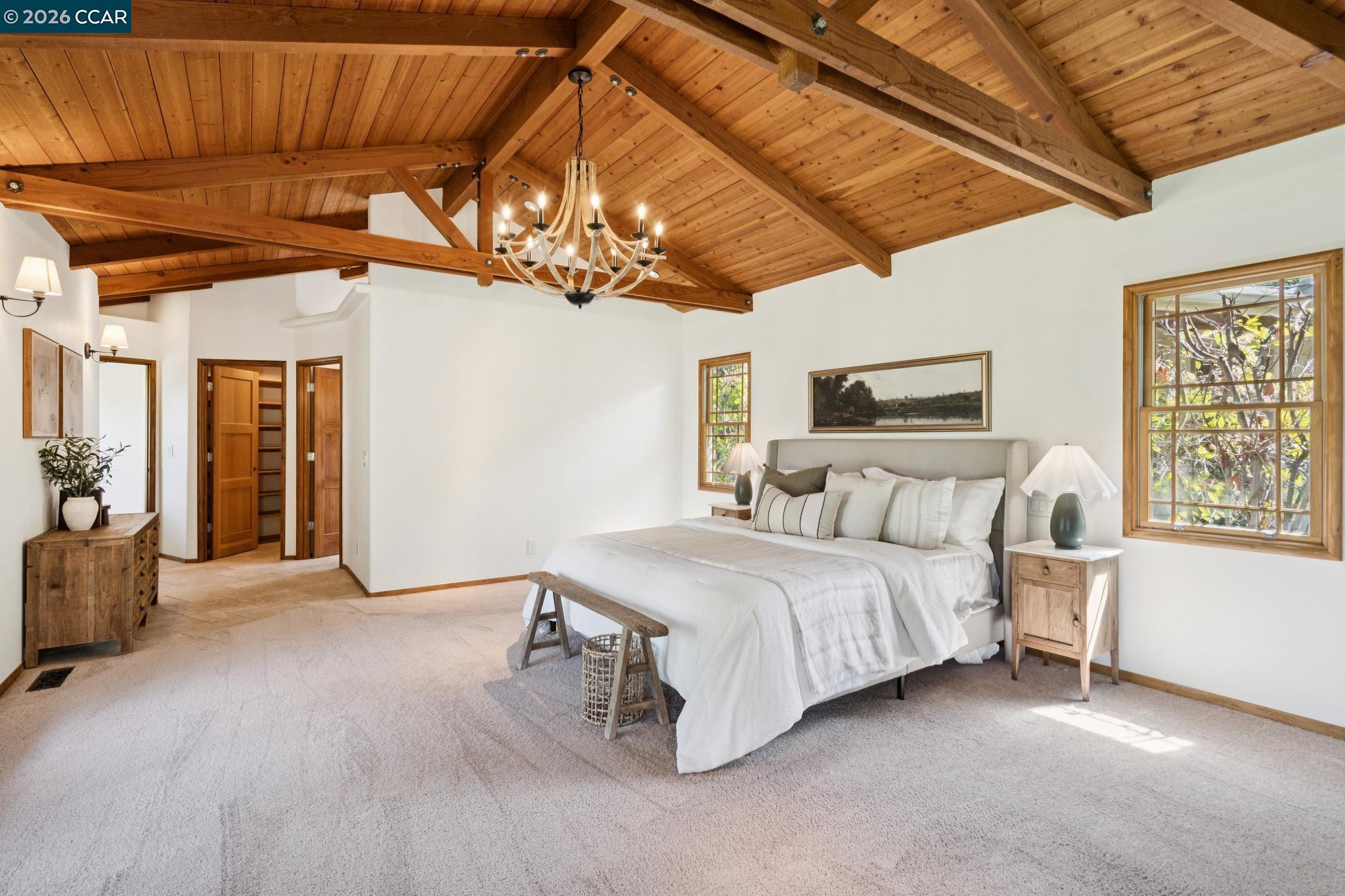 20 Santa Rita Drive Walnut Creek, CA 94596 - Photo 16 of 44 a spacious bedroom with a bed a chandelier and a dresser