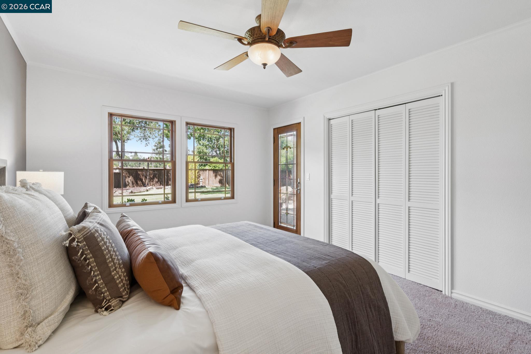20 Santa Rita Drive Walnut Creek, CA 94596 - Photo 20 of 44 a bedroom with a large bed and a chandelier fan