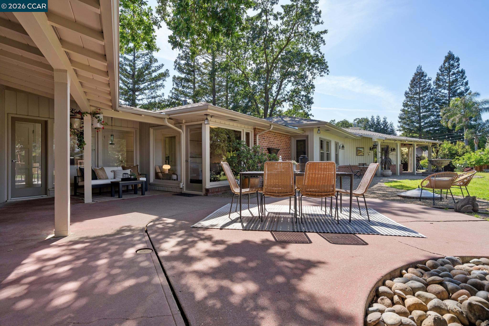 20 Santa Rita Drive Walnut Creek, CA 94596 - Photo 30 of 44 a view of a patio with table and chairs and potted plants