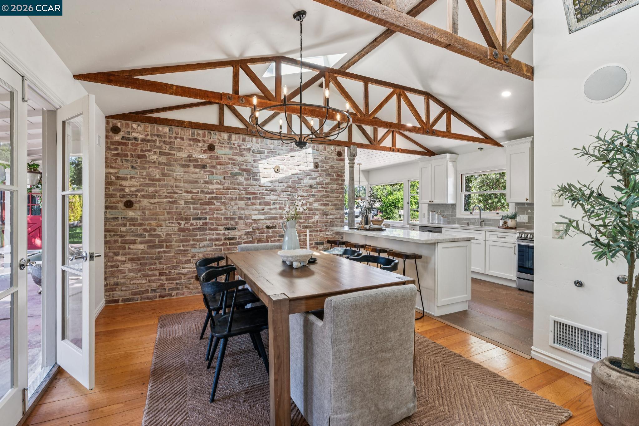 20 Santa Rita Drive Walnut Creek, CA 94596 - Photo 6 of 44 a kitchen with stainless steel appliances kitchen island granite countertop a table chairs in it and wooden floors