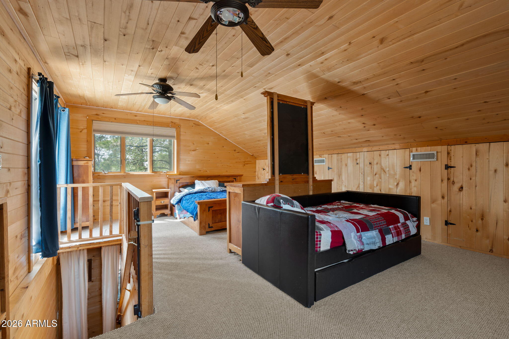 2095 Ranger Road Overgaard, AZ 85933 - Photo 11 of 25 a bed room with a bed and a chandelier
