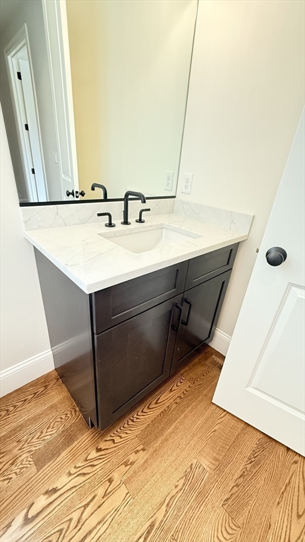 18 Powder House Lane, Unit 5 Walpole, MA 02032 - Photo 15 of 20 a bathroom with a sink and a mirror