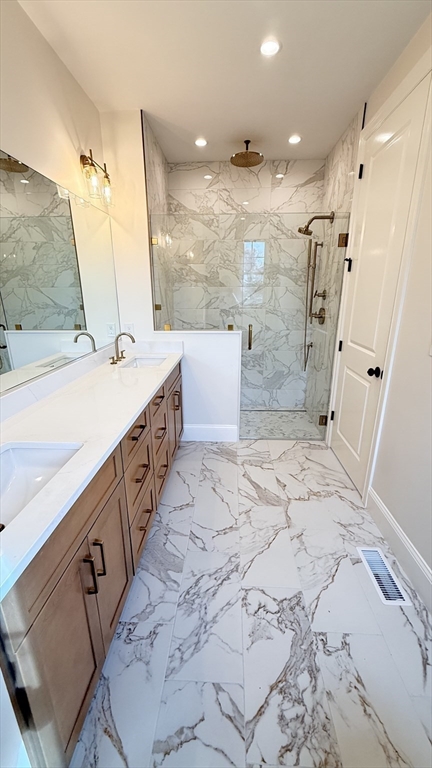 18 Powder House Lane, Unit 5 Walpole, MA 02032 - Photo 16 of 20 a bathroom with double vanity and a shower
