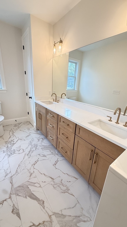 18 Powder House Lane, Unit 5 Walpole, MA 02032 - Photo 18 of 20 a spacious bathroom with a sink and a mirror