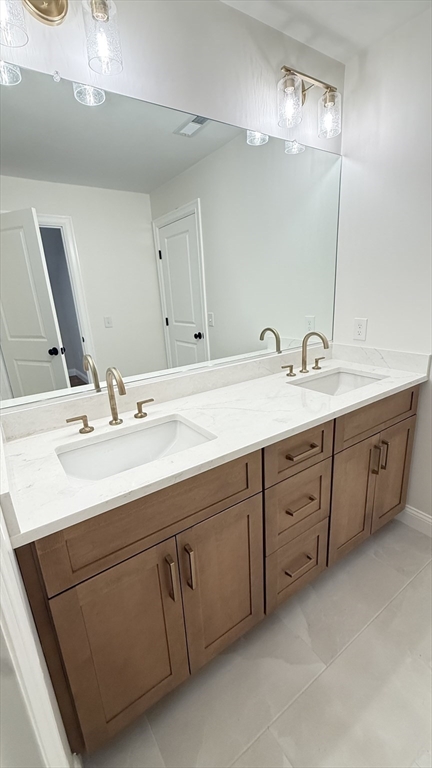 18 Powder House Lane, Unit 5 Walpole, MA 02032 - Photo 10 of 20 a bathroom with a sink double vanity and a mirror
