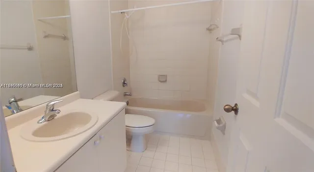 a view of a small space with wooden floor and a window