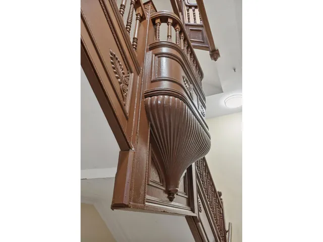 a view of staircase with white walls and a floor