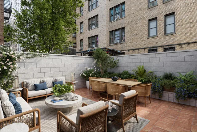 a view of a patio with couches table and chairs potted plants and potted plants