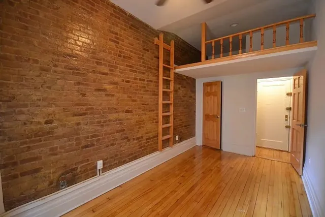 a view of a balcony with wooden floor
