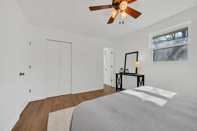 a bedroom with a bed and a painting on the wall