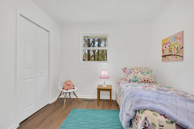 a bedroom with a bed and a workspace