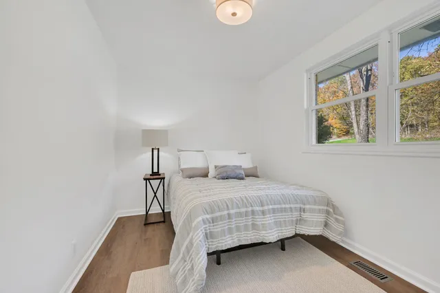 a bedroom with a bed and window