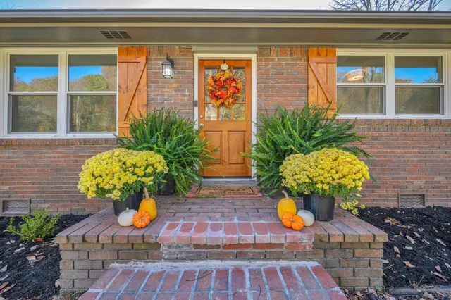 a vase of flowers sitting on a floor
