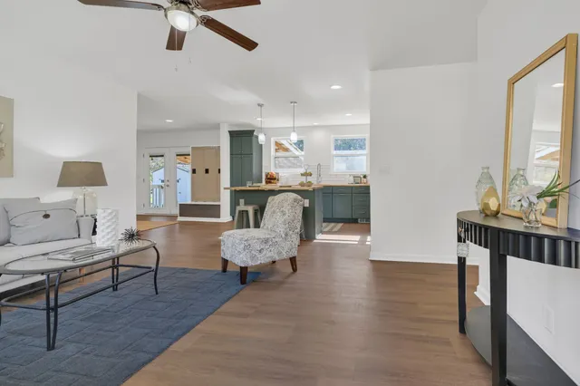 a living room with furniture and a wooden floor