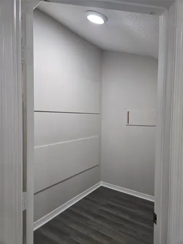 a bathroom with a granite countertop bathtub and toilet