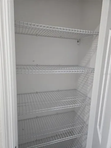 an empty room with wooden floor and closet