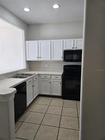 a kitchen with a stove a sink and a refrigerator